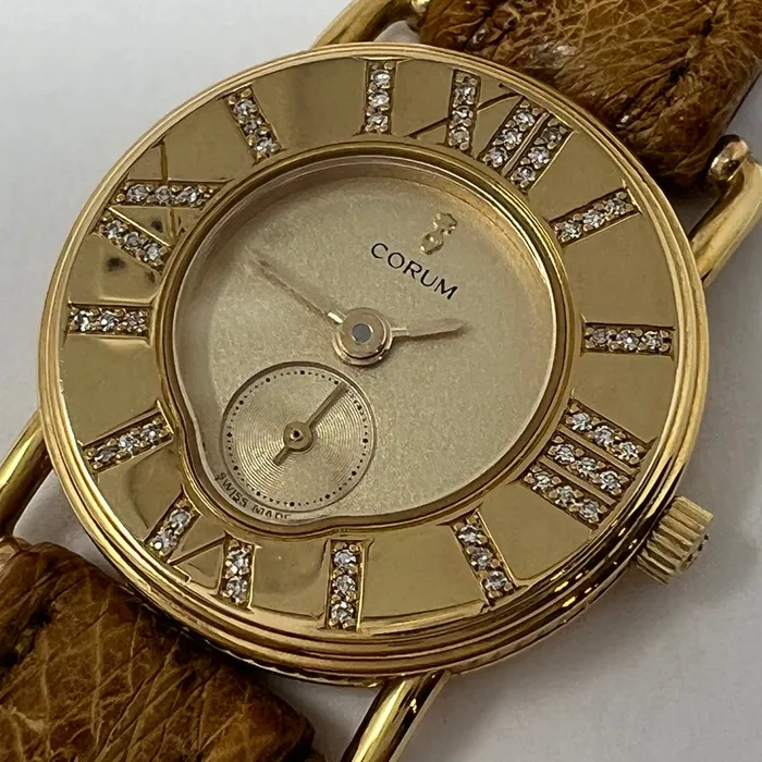 PreStyled Sets Corum Corum 18K Gold Watch with Roman Numerals and Tan Ostrich Strap